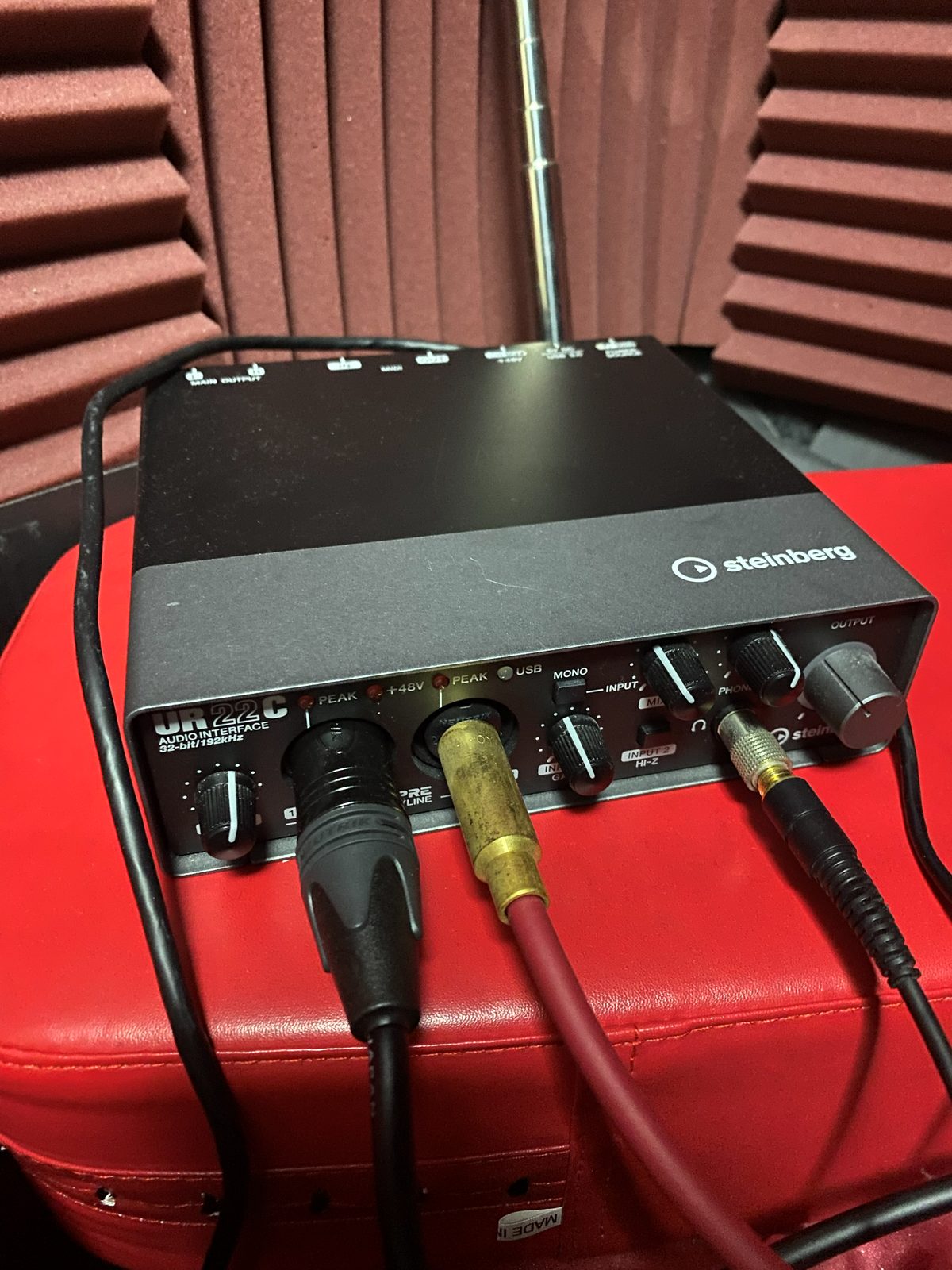 Steinberg UR22C audio interface with XLR and phone cables connected to the front, PEAK and +48V indicators and a GAIN knob visible
